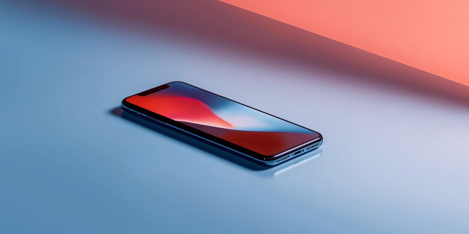 A modern smartphone on a blue and coral gradient surface